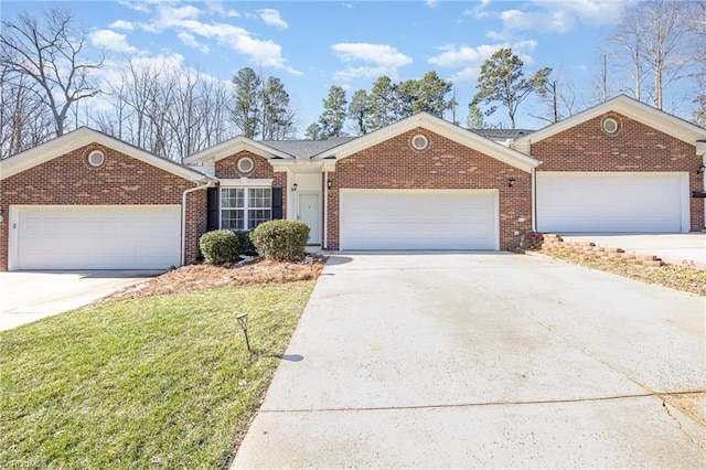 ranch-style house featuring an attached garage, driveway, a front yard, and brick siding