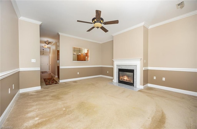 unfurnished living room featuring ceiling fan, light carpet, a premium fireplace, baseboards, and ornamental molding