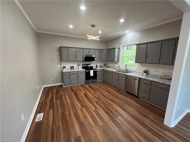 kitchen with gray cabinetry, stainless steel appliances, dark wood-type flooring, and a sink