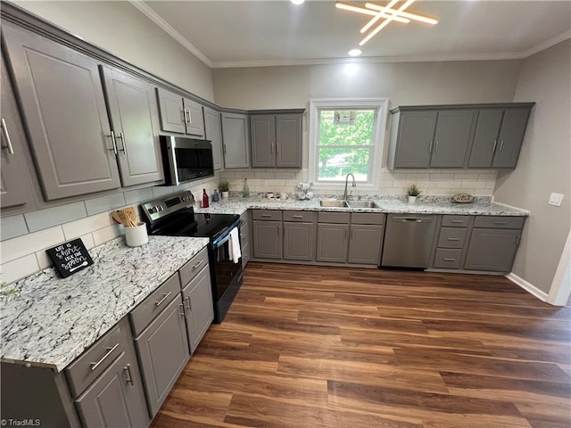 kitchen with stainless steel appliances, gray cabinets, and a sink
