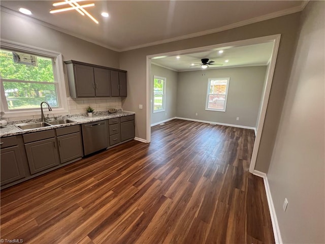 kitchen featuring stainless steel dishwasher, a sink, dark wood-style floors, ornamental molding, and gray cabinets