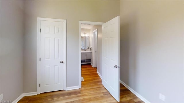 unfurnished bedroom with light wood-style floors and baseboards