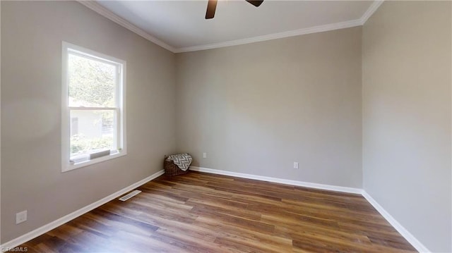 empty room with ceiling fan, a wealth of natural light, wood finished floors, and baseboards