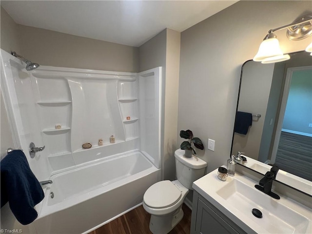 full bath featuring shower / washtub combination, wood finished floors, toilet, and vanity