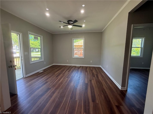 unfurnished room featuring dark wood-type flooring, a healthy amount of sunlight, and baseboards