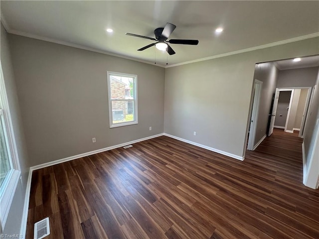unfurnished room featuring baseboards, crown molding, and dark wood-style floors