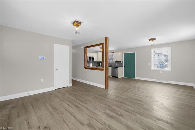 unfurnished living room featuring hardwood / wood-style flooring