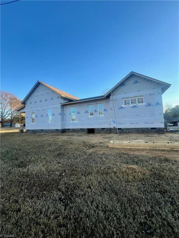 view of side of home featuring a lawn