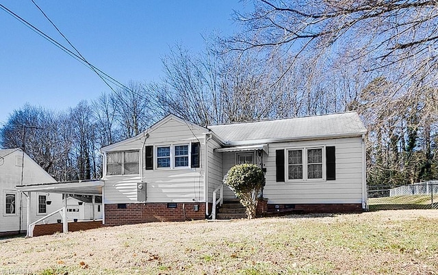 view of front facade featuring a front yard and a carport