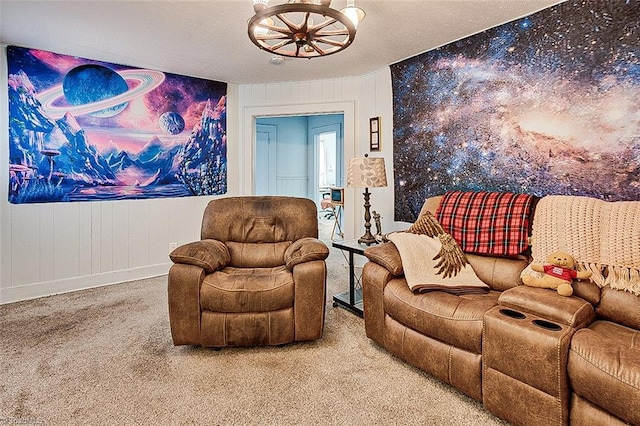 sitting room with a notable chandelier and carpet floors