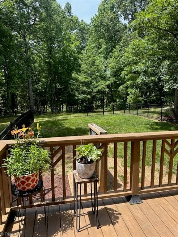 wooden terrace with a lawn