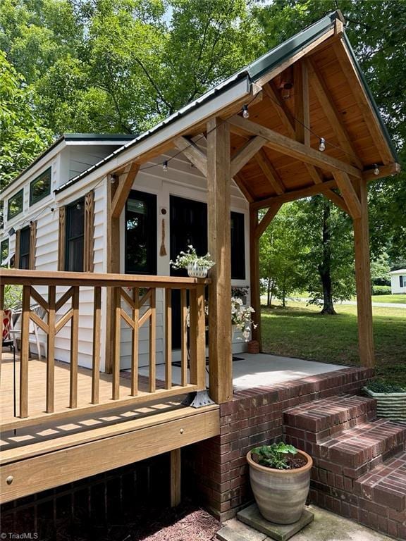 exterior space with a lawn and a wooden deck