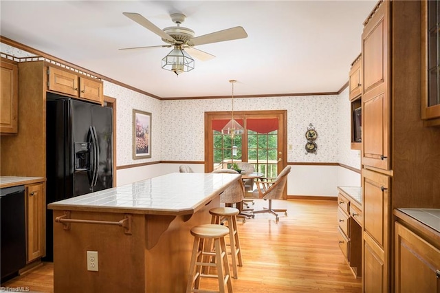 102 Shawnee Cir, Lexington, NC 27295 - kitchen with crown molding, tile counters, wallpapered walls, wainscoting, and light wood finished floors