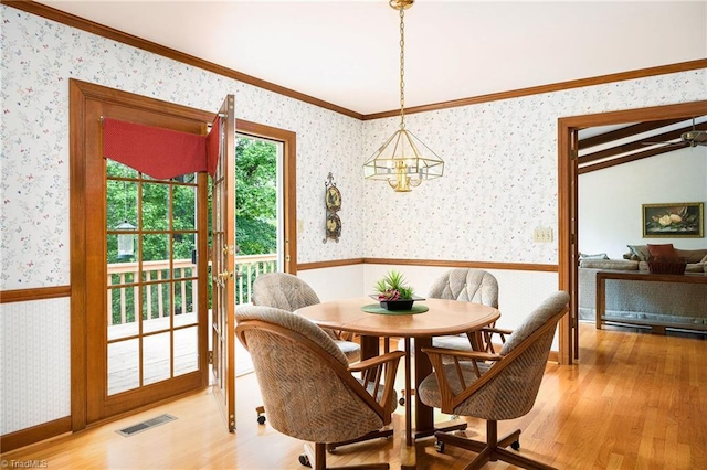 102 Shawnee Cir, Lexington, NC 27295 - dining room featuring wallpapered walls, light wood-style floors, a chandelier, crown molding, and a wainscoted wall