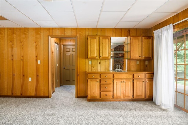 102 Shawnee Cir, Lexington, NC 27295 - kitchen with wooden walls, light carpet, and brown cabinets