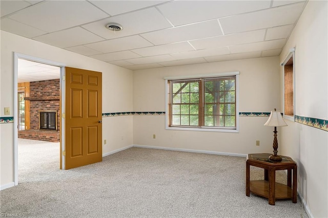 102 Shawnee Cir, Lexington, NC 27295 - spare room with carpet flooring, a fireplace, a drop ceiling, and baseboards