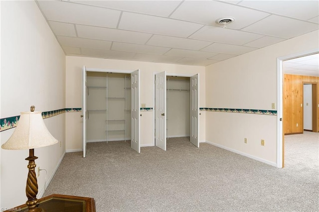 102 Shawnee Cir, Lexington, NC 27295 - unfurnished bedroom with two closets, carpet, a paneled ceiling, and baseboards