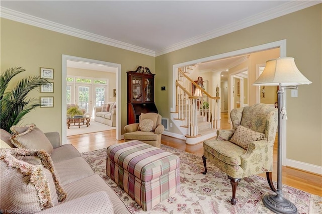 4208 Bitternut Trl, Greensboro, NC 27410 - living room with ornamental molding, stairway, wood finished floors, and baseboards