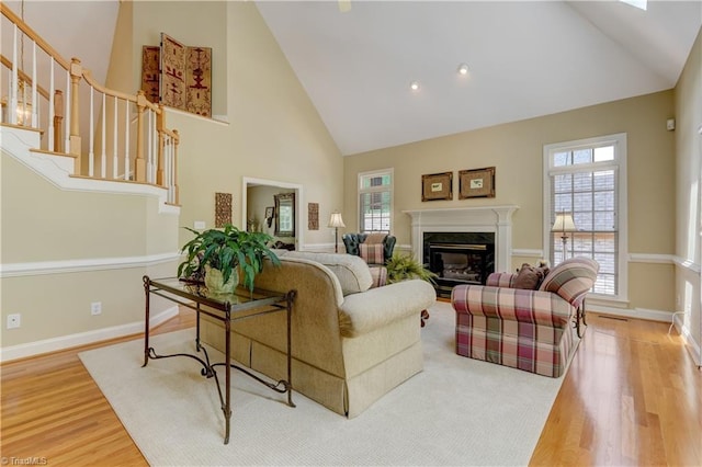 4208 Bitternut Trl, Greensboro, NC 27410 - living area with high vaulted ceiling, wood finished floors, a premium fireplace, and baseboards