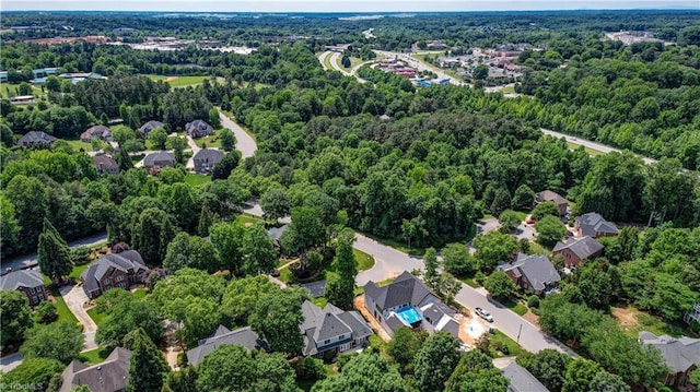 4208 Bitternut Trl, Greensboro, NC 27410 - aerial view of property's location with nearby suburban area and a forest
