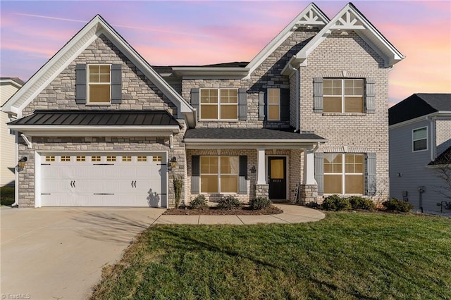 craftsman house with a lawn and a garage