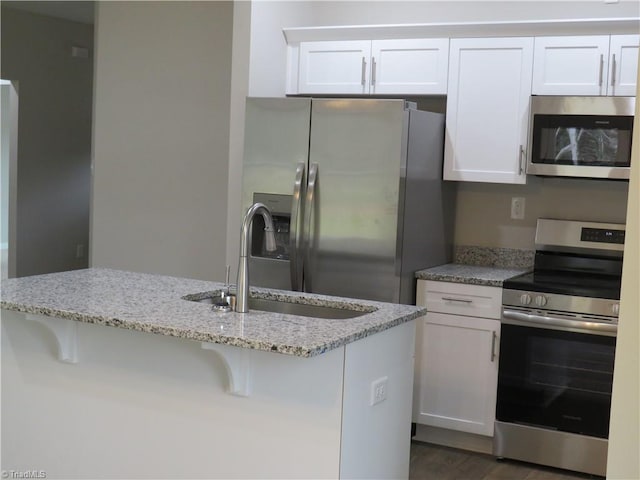 kitchen featuring appliances with stainless steel finishes, sink, and white cabinets