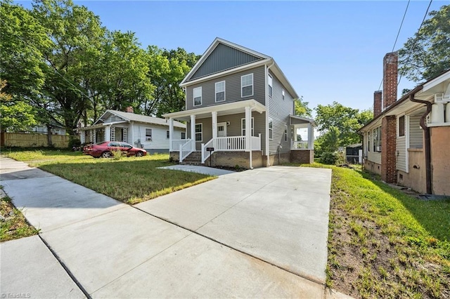 907 Caldwell St, Greensboro, NC 27406 - american foursquare style home featuring covered porch, concrete driveway, and a front lawn