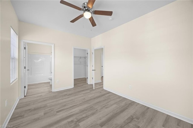 907 Caldwell St, Greensboro, NC 27406 - unfurnished bedroom with light wood-style floors, baseboards, a spacious closet, and a closet