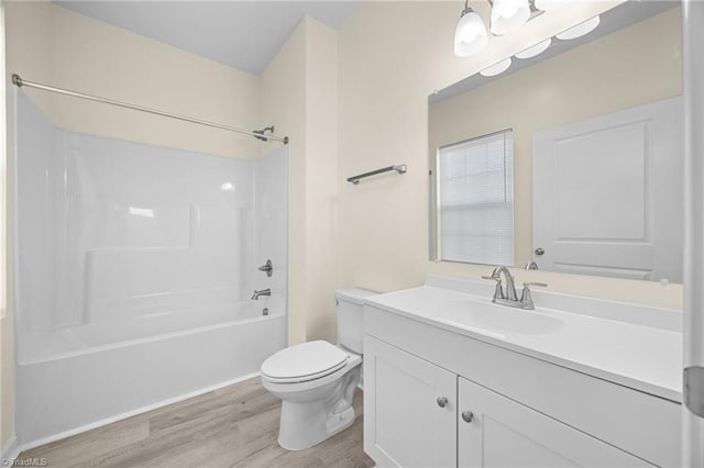907 Caldwell St, Greensboro, NC 27406 - bathroom with wood finished floors, toilet, shower / bathtub combination, and vanity