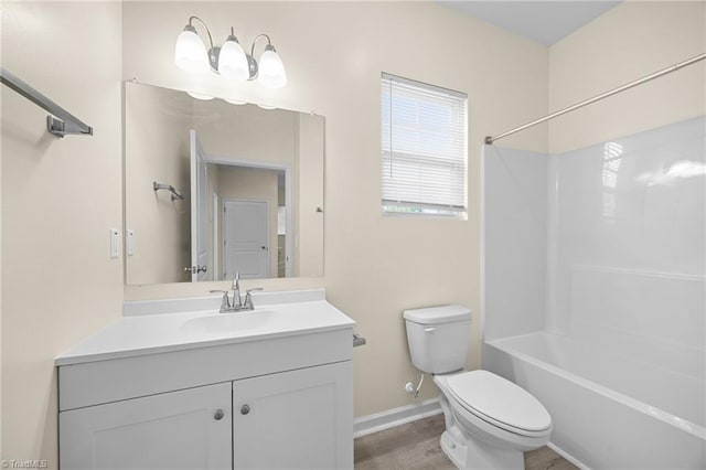907 Caldwell St, Greensboro, NC 27406 - full bathroom with toilet, baseboards, vanity, and tub / shower combination