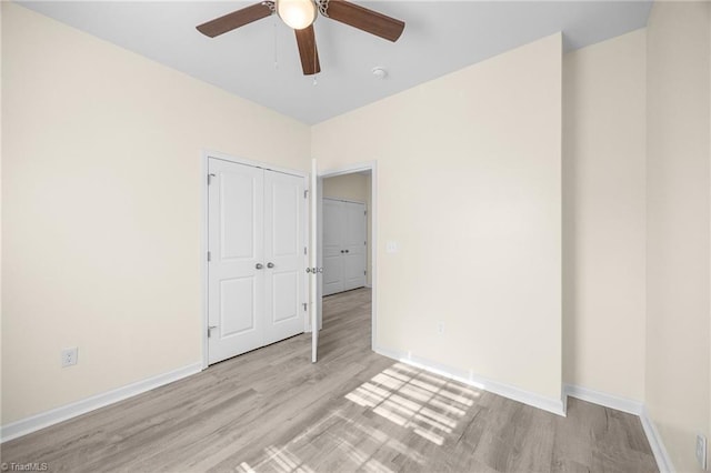 907 Caldwell St, Greensboro, NC 27406 - unfurnished bedroom featuring wood finished floors, baseboards, and a closet