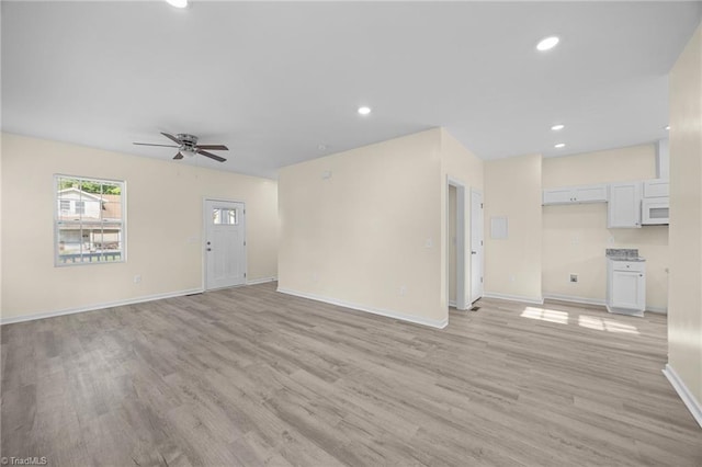 907 Caldwell St, Greensboro, NC 27406 - unfurnished living room featuring light wood finished floors, a ceiling fan, baseboards, and recessed lighting