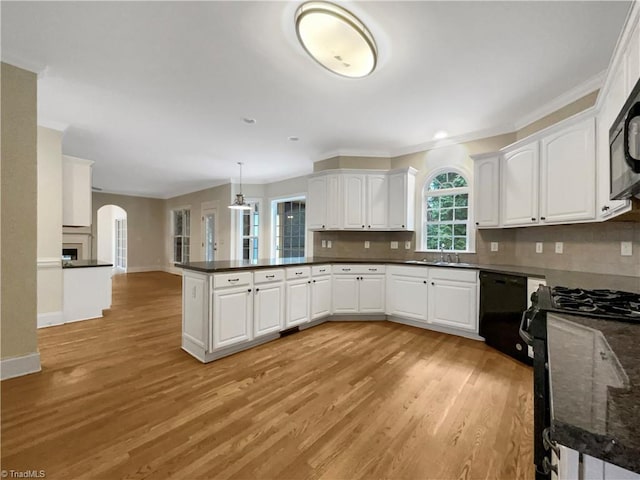 kitchen with white cabinetry, kitchen peninsula, black appliances, tasteful backsplash, and pendant lighting