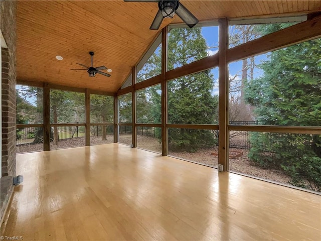 unfurnished sunroom featuring vaulted ceiling, ceiling fan, and wood ceiling