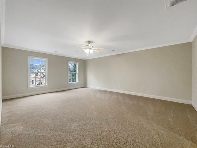 carpeted spare room with ceiling fan and ornamental molding