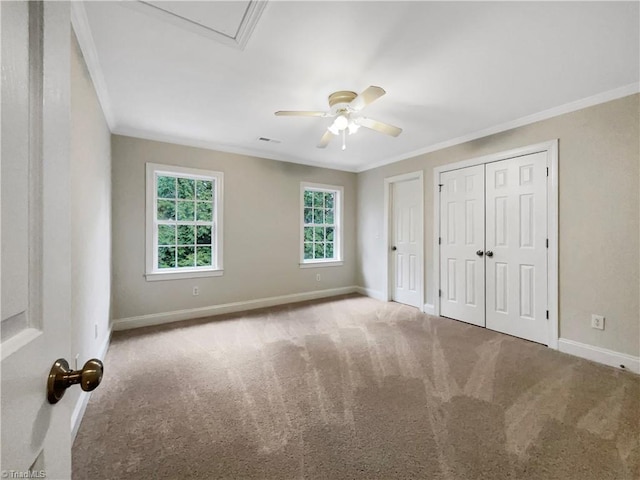 unfurnished bedroom featuring carpet floors, crown molding, and ceiling fan