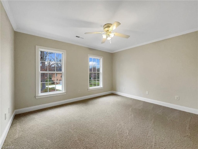 carpeted spare room featuring ornamental molding and ceiling fan