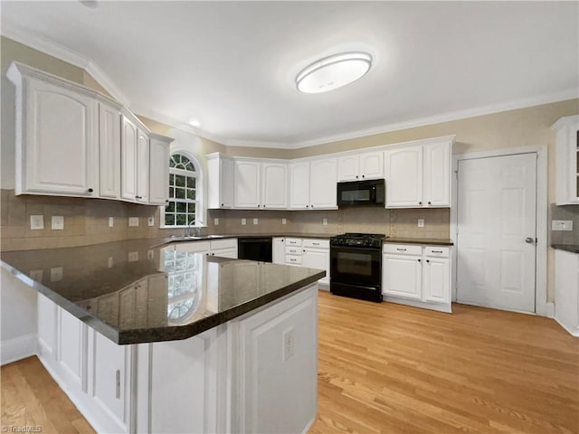 kitchen featuring white cabinetry, black appliances, light hardwood / wood-style flooring, and kitchen peninsula