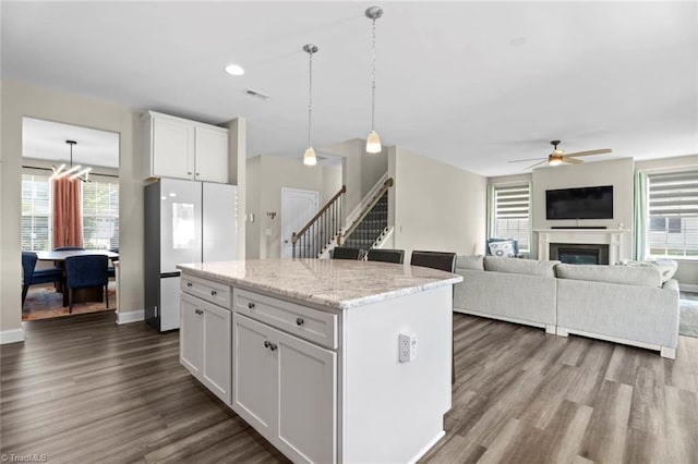 1827 Deveron Ct, Kernersville, NC 27284 - kitchen with freestanding refrigerator, ceiling fan, white cabinetry, dark wood-style flooring, and a kitchen island