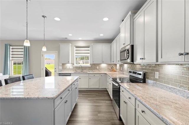 1827 Deveron Ct, Kernersville, NC 27284 - kitchen with stainless steel appliances, a center island, white cabinets, tasteful backsplash, and recessed lighting