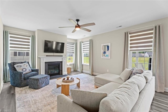 1827 Deveron Ct, Kernersville, NC 27284 - living area featuring wood finished floors, ceiling fan, and plenty of natural light