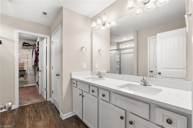 1827 Deveron Ct, Kernersville, NC 27284 - full bath featuring double vanity, wood finished floors, a spacious closet, and a shower with shower door