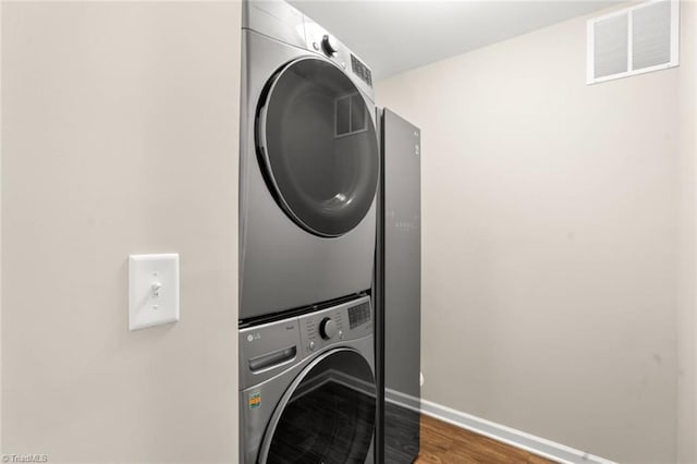 1827 Deveron Ct, Kernersville, NC 27284 - laundry room with stacked washer and clothes dryer and wood finished floors
