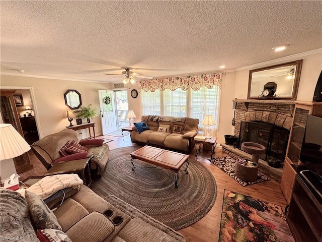 7658 Salem Chapel Rd, Walnut Cove, NC 27052 - living room featuring wood finished floors, crown molding, a fireplace, a textured ceiling, and ceiling fan