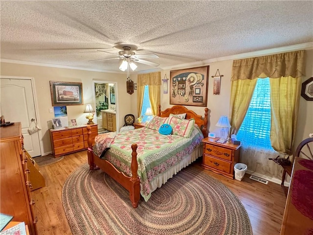 7658 Salem Chapel Rd, Walnut Cove, NC 27052 - bedroom featuring ornamental molding, light wood-style floors, a textured ceiling, and a ceiling fan