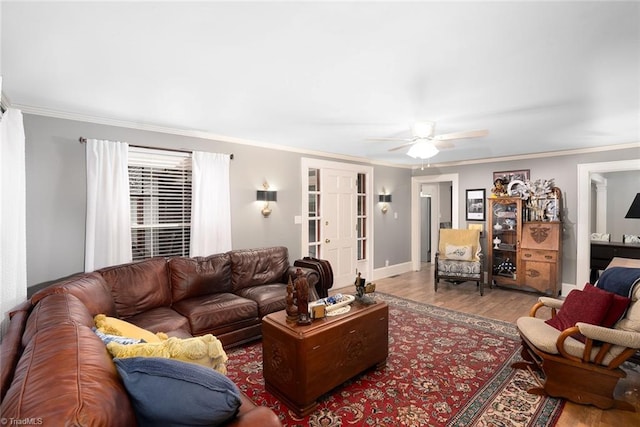 living room featuring crown molding, hardwood / wood-style floors, and ceiling fan