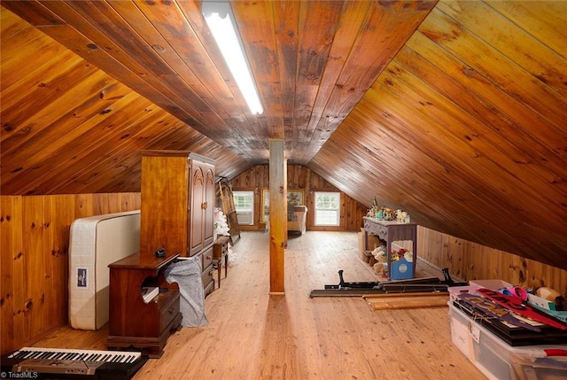 additional living space featuring wooden walls, light hardwood / wood-style flooring, vaulted ceiling, and wood ceiling