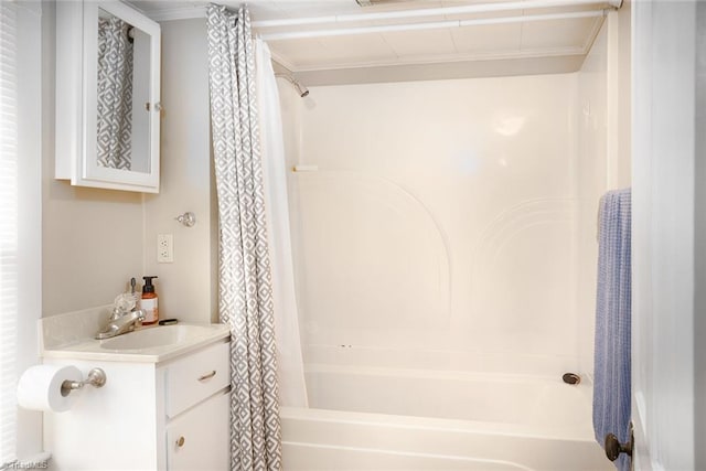 bathroom with shower / bathtub combination with curtain, ornamental molding, and vanity