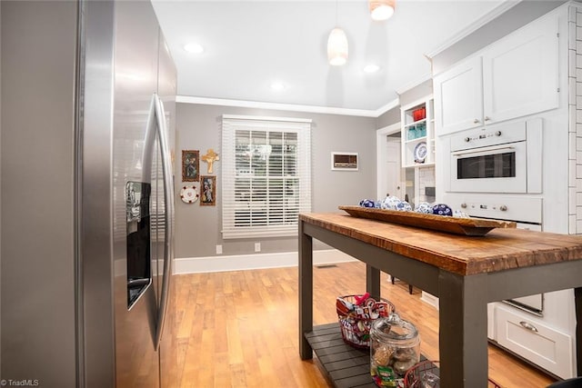 kitchen with pendant lighting, wood counters, stainless steel fridge with ice dispenser, and white cabinetry