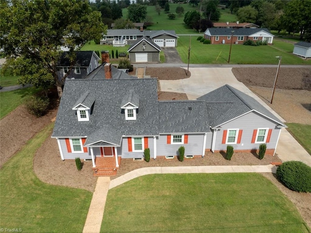 view of front of home with a front yard and a garage